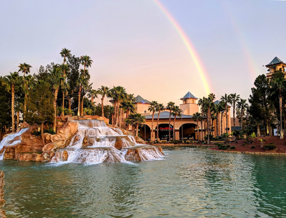 CasaBlanca Resort and Casino palm-lined pool waterfall with rainbow arch in Mesquite Nevada